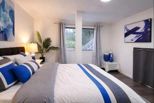 a bedroom with a large bed and a window at Remodeled, Spacious, Modern Retreat 5 BR, 3BA, 2KIT in Shoreline