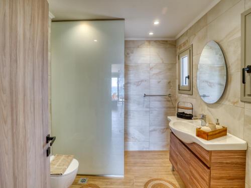 a bathroom with a sink and a shower and a toilet at Villa Elusia in Kefalos