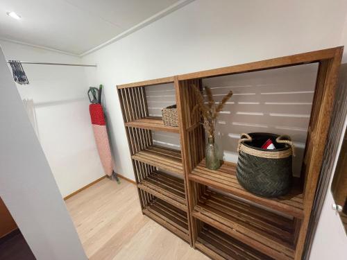 a closet with wooden shelves in a room at Le Petit Pêcheur in Étang-Salé