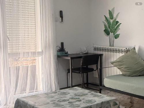 a bedroom with a desk and a bed and a window at Mama house in El Marsa