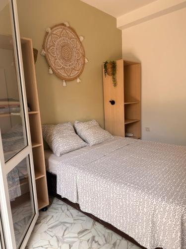 a bedroom with a bed and a shelf at Mama house in El Marsa