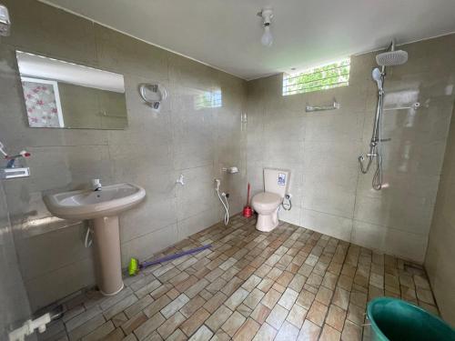 a bathroom with a sink and a toilet at SN Villa in Jaffna