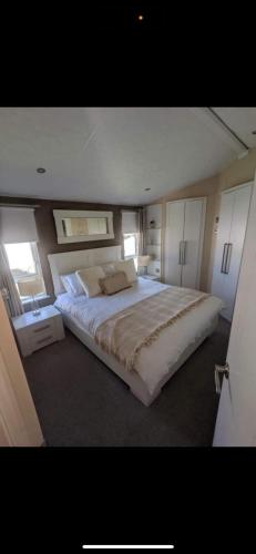 a large bedroom with a large bed in it at Craig Tara Beach Lodge in Ayr