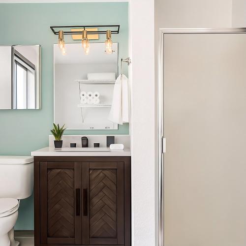 a bathroom with a sink and a toilet and a mirror at Remodeled, Spacious, Modern Retreat 5 BR, 3BA, 2KIT in Shoreline