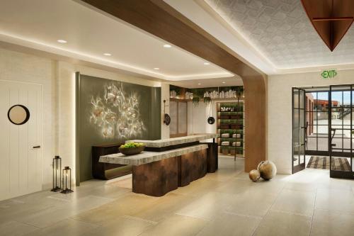 a lobby with a large marble counter in a room at The Harborvale, Autograph Collection in Burlington