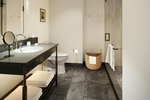 a bathroom with a sink and a toilet at The Harborvale, Autograph Collection in Burlington