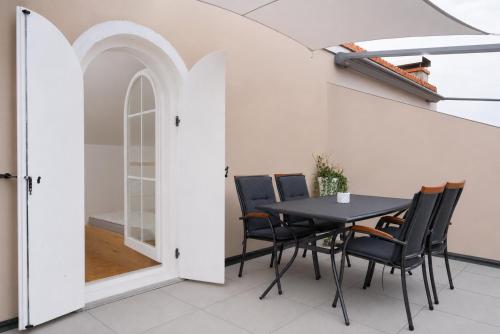 a dining room with a table and chairs at Sunny Apartment with Terrace in Ankaran