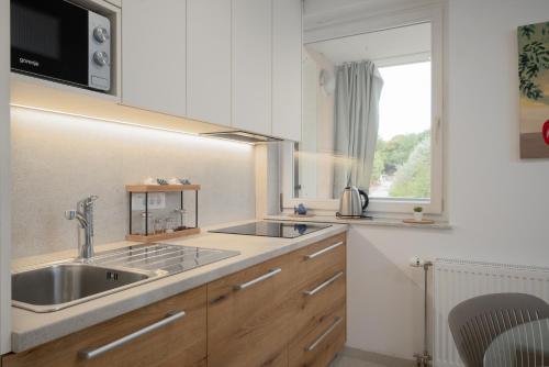 a kitchen with a sink and a window at Sunny Apartment with Terrace in Ankaran