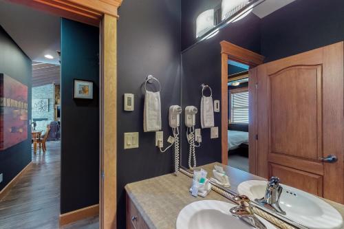 a bathroom with a sink and a mirror at Tree Tops 15 in Big White