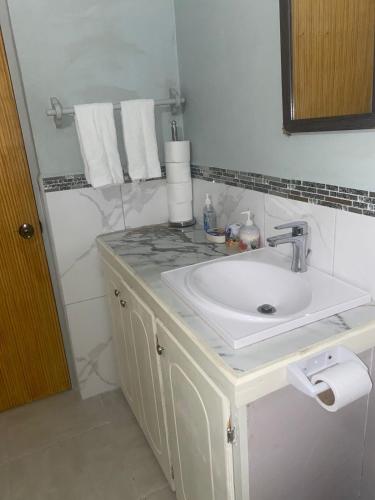 a white bathroom with a sink and a mirror at Country Green in La Feuillet