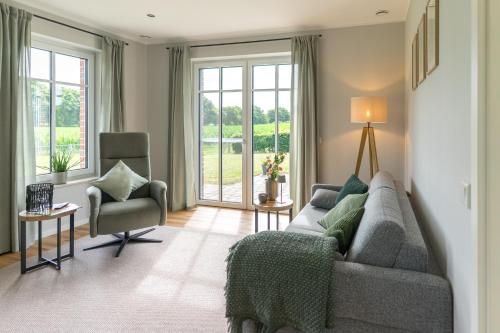 a living room with a couch and a chair at Ferienwohnung Landblick in Borken