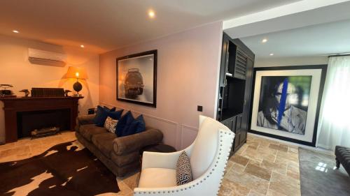 a living room with a couch and a chair at Moulin Royale in Saint-Etienne-Roilaye