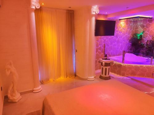 a bathroom with a tub and a shower with purple lights at GLS Priamos in Piraeus
