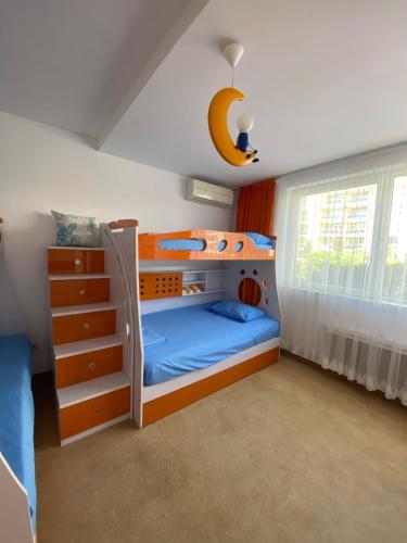 a bedroom with a bunk bed with a blue bed at Bellevue Beachfront Paradise in Ravda