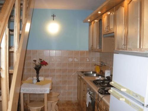 a small kitchen with a cross on the wall at Agroturystyka u Jasienka in Mrukowa