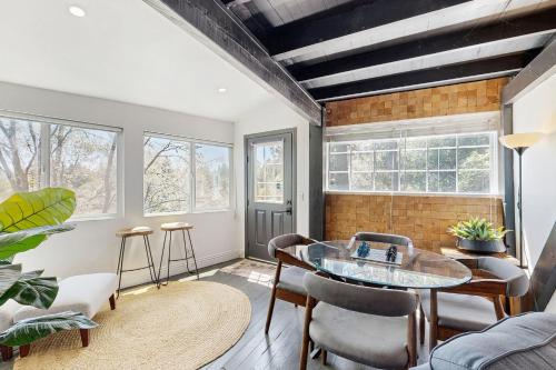 a living room with a glass table and chairs at The Polished Pine in Crestline