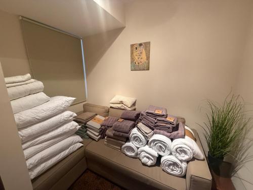 a room with a pile of towels on a couch at Nautica Residence in Balatonfüred