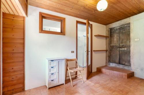 a room with a desk and a window and a wooden ceiling at Spacious 4BR Home with Lake View in Nesso