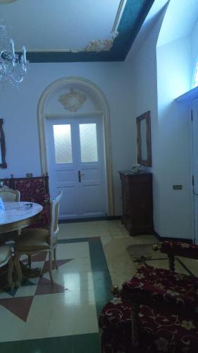 a living room with a table and a door at Casa Di Bella Taormina in Roccalumera