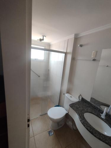 a bathroom with a toilet and a sink at Thermas place 406 in Caldas Novas