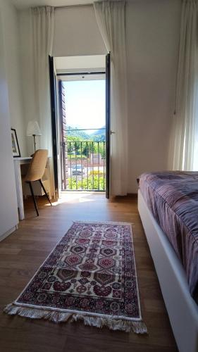 a bedroom with a bed and a door with a rug at Affittacamere Borgo Antico in Venzone