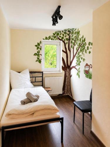 a bedroom with a tree mural on the wall at Ferienwohnung Bergpanorama Waldweg in Altmünster