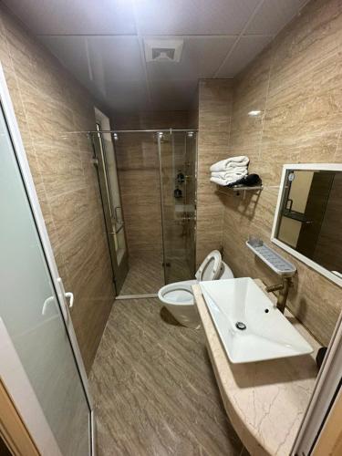 a bathroom with a shower and a toilet and a sink at Hanoi Better Hotel & spa in Hanoi