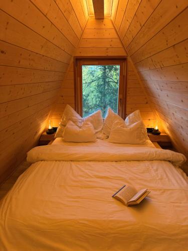 a bed in a cabin with two books on it at Lune Dunakanyar in Esztergom