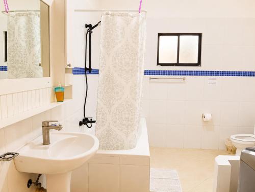 a bathroom with a sink and a shower curtain at Best View 2 Adults Only in La Laguna
