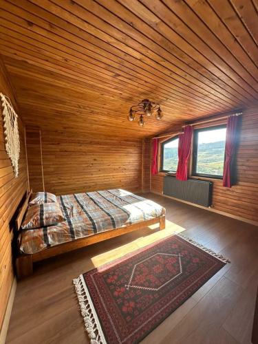 a bedroom with a bed in a wooden room at Çambaşı Villa Bella in Ordu
