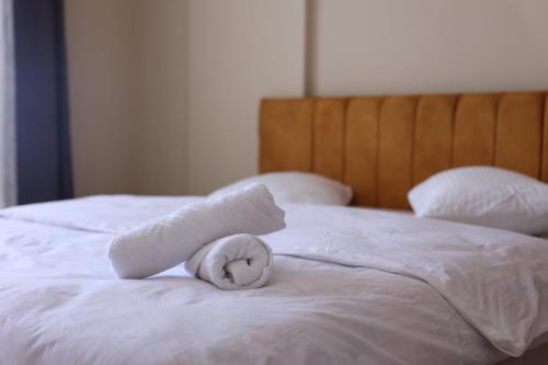 a white towel on top of a white bed at Gold Apart Otel in Mersin