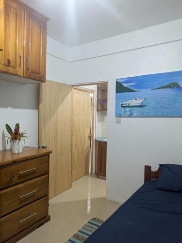 a bedroom with a bed and a painting of a boat at New Beginnings in Salisbury