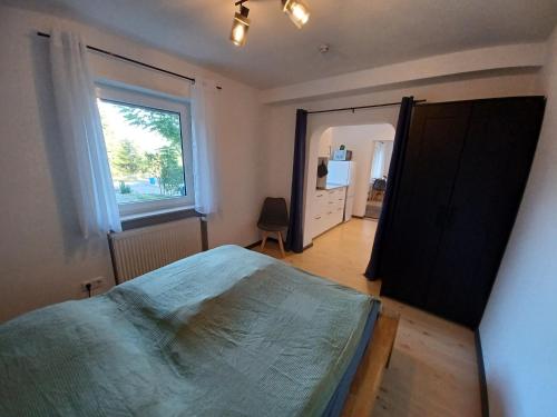 a bedroom with a large bed and a window at Moderne Ferienwohnung Am Goldberg in Neuleiningen