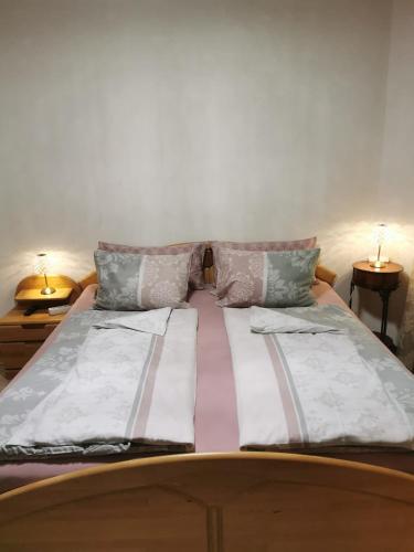 a bed with two pillows on top of it at Ferienhaus Burgblick in Treffen