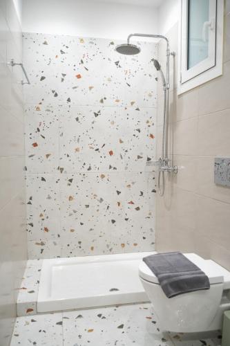 a bathroom with a shower and a toilet at Boho Nook Apartment in Rethymno