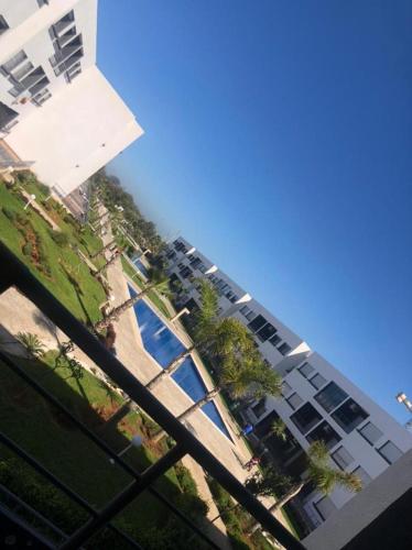 a view of a building with trees in front of it at Appartement mansoria in Mansouria