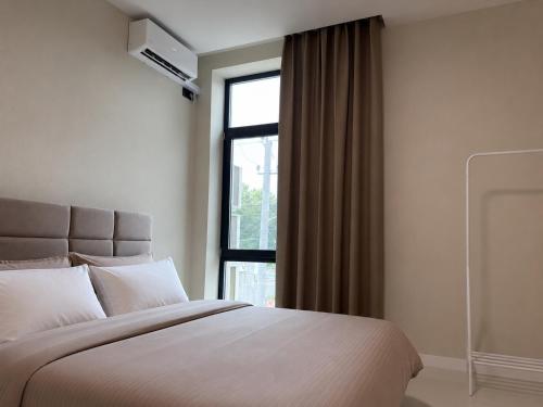 a bedroom with a large bed and a window at Luxe House Odessa Private Jacuzzi BBQ, Free Parking in Odesa
