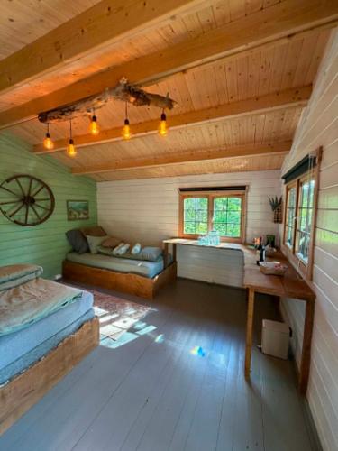 a bedroom with two beds and a table in a room at opplevelses hytta badestamp ridning osv in Skien