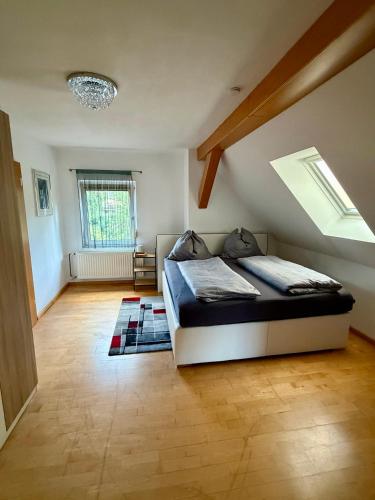 a bedroom with a bed and a skylight at Sabes Ferienwohnung in Altglandorf