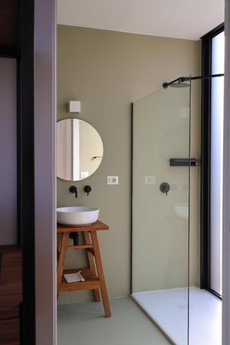 a bathroom with a sink and a mirror at Quercia Private Nature Retreat in Maglie