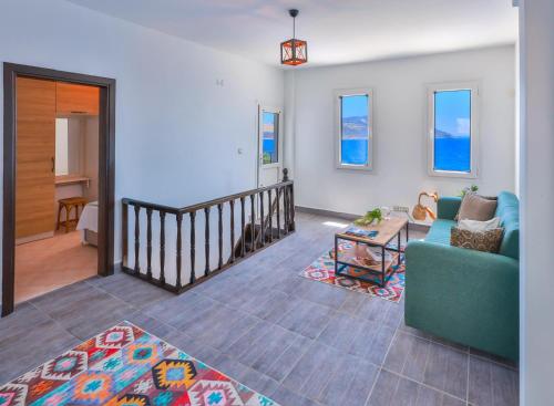 a living room with a couch and a table at Panaroma Meis Suits in Kaş