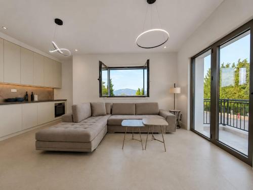 a living room with a couch and a table at Lux Studio Lustica Bay and Car in Luštica