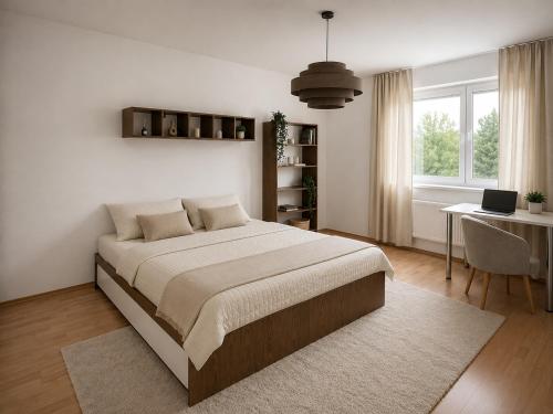a bedroom with a large bed and a desk at Veľký rodinný apartmán s výhľadom na zeleň a hory v centre Piešťan s parkovaním in Piešťany