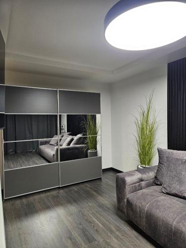 a living room with a bed and a couch at Comfort View Apartment in Liepāja