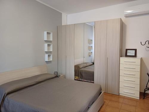 a bedroom with a bed and a dresser and a mirror at Luna in Novara