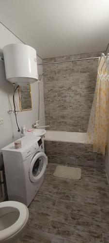 a bathroom with a toilet and a bath tub at Жилье у моря in Odesa