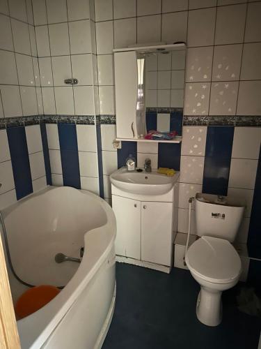a bathroom with a tub and a toilet and a sink at Квартира новая in Odesa