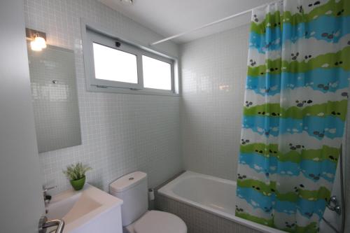 une salle de bain avec toilettes et rideau de douche dans l'établissement Apartment El Medano Sunrises, à El Médano