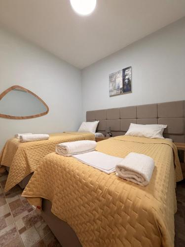 two beds sitting next to each other in a bedroom at Terra Kampos Chios in Chios