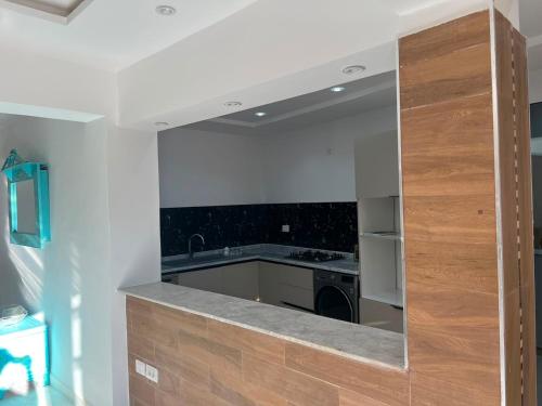 a kitchen with a sink and a mirror at Dar El Baraka in Ghar el Fabs